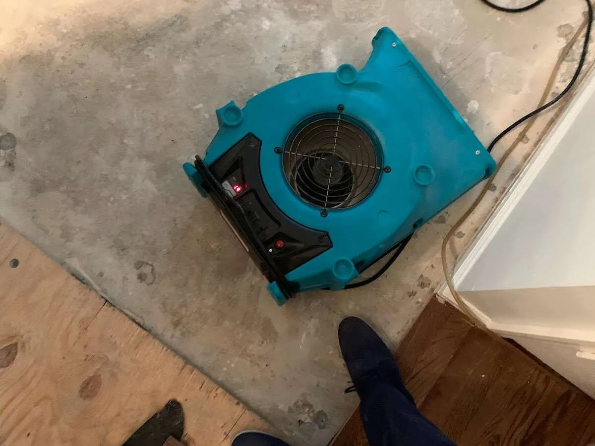 Air mover drying subfloor during Commercial Water Damage Restoration in Akron